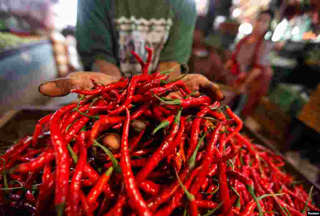 A trader displays chilis for sale at traditional market in Jakarta, Indonesia.