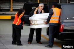 Staff of a funeral home receive the coffin containing the body of Jakelin Caal before her funeral, at La Aurora International Airport in Guatemala City, Guatemala, Dec. 23, 2018.