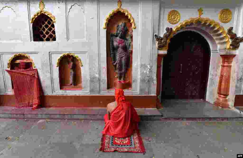 An Indian devotee offers prayer ahead of the annual Ambubachi Mela festival at the Kamakhya temple in Guwahati.