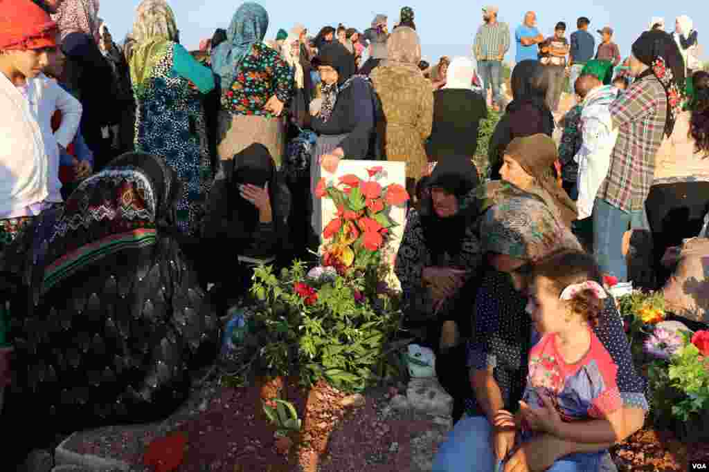 Displaced Afrin people visit the graves of their beloved ones in the eid