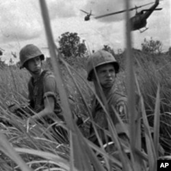 Two U.S. paratroopers seen during landing operations in Vietnam, north of Saigon, 1965.