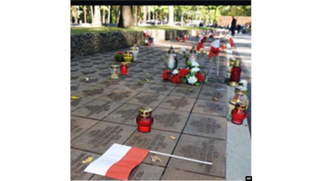 Candles, flowers and Polish flags mark gravestones of Polish officers killed 70 years ago by Soviet secret police in the Katyn massacre, during commemorating events in Kharkiv, Ukraine (File)
