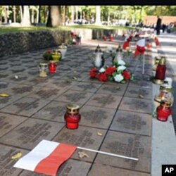 Candles, flowers and Polish flags mark gravestones of Polish officers killed 70 years ago by Soviet secret police in the Katyn massacre, during commemorating events in Kharkiv, Ukraine (File)