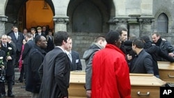 Relatives leave the funeral of Vincent Delory and Antoine De Leocour in Linselles, northern France, 17 Jan 2011