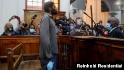 Zandile Christmas Mafe, a suspect accused of breaking into Parliament when the fire started, appears in the Cape Town Magistrate Court, in Cape Town, South Africa, Jan. 4, 2022. 