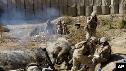 Marines of 2nd Battalion 2 Marines of 2nd Marine Expeditionary Brigade fire mortar rounds from their forward operating base in Mian Poshteh in Helmand Province, 23 Nov 2009