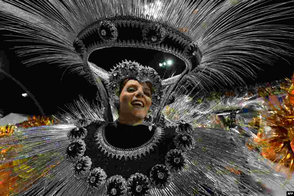 A dancer of the Imperio de Casa Verde samba school performs during the second night of carnival parade at the Sambadrome in Sao Paulo, Brazil.