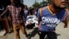 Rescue workers move a body after an attack on the Chinese consulate, where blasts and shots were heard, in Karachi, Pakistan, Nov. 23, 2018.