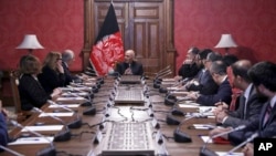 In this photo released by the Afghan Presidential Palace, Afghan President Ashraf Ghani, center, speaks to U.S. peace envoy Zalmay Khalilzad, third left, at the presidential palace in Kabul, Afghanistan, Jan. 28, 2019. 