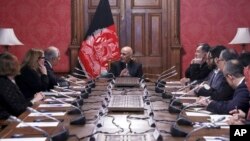 FILE - In this photo released by the Afghan Presidential Palace, Afghan President Ashraf Ghani, center, speaks to U.S. peace envoy Zalmay Khalilzad, third left, at the presidential palace in Kabul, Afghanistan, Jan. 28, 2019. 