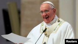 Pope Francis smiles as he delivers his messages during a mass at the Cathedral church in Manila in the Philippines, Jan. 16, 2015.