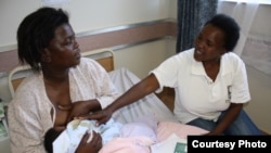 A mother breastfeeds a child in South Africa. (VOA/D.Taylor)