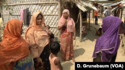 Camp committee member Ayesha Khatun, right, listens to fellow refugees. Taking care of simple things is often not so easy in a refugee camp where many families have no income and depend entirely on handouts.