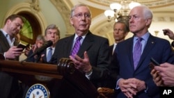 Senate Majority Leader Mitch McConnell, R-Ky., joined by Sen. Roy Blunt, R-Mo., left, Sen. John Thune, R-S.D., second from right, and Majority Whip John Cornyn, R-Texas, right, speaks with reporters about the confirmation for President Donald Trump's Supreme Court nominee.