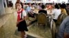 A young North Korean student waits in the dining hall of the Ongnyugwan, a popular noodle restaurant, Sept. 1, 2014 in Pyongyang