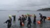 Swimmers enter the water for a mid-October, 1.6 km "excursion" at Alki Beach in Seattle. (VOA / T. Banse)