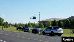 A helicopter lands near Noblesville West Middle School in Noblesville, Indiana, May 25, 2018 in this still image obtained from social media video. Officials say the shooting suspect asked to be excused from class before returning with two handguns.