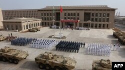 FILE - Chinese People's Liberation Army personnel attend the opening ceremony of China's new military base in Djibouti, Aug. 1, 2017.