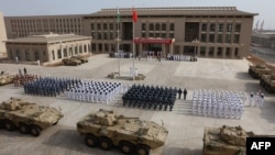 FILE - Chinese People's Liberation Army personnel attend the opening ceremony of China's new military base in Djibouti, Aug. 1, 2017.