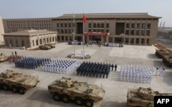 FILE - Chinese People’s Liberation Army personnel attend the opening ceremony of China’s new military base in Djibouti, Aug. 1, 2017.