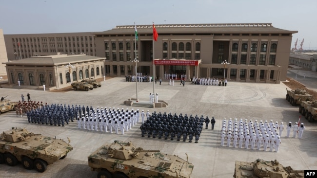 FILE - Chinese People's Liberation Army personnel attend the opening ceremony of China's new military base in Djibouti, Aug. 1, 2017.