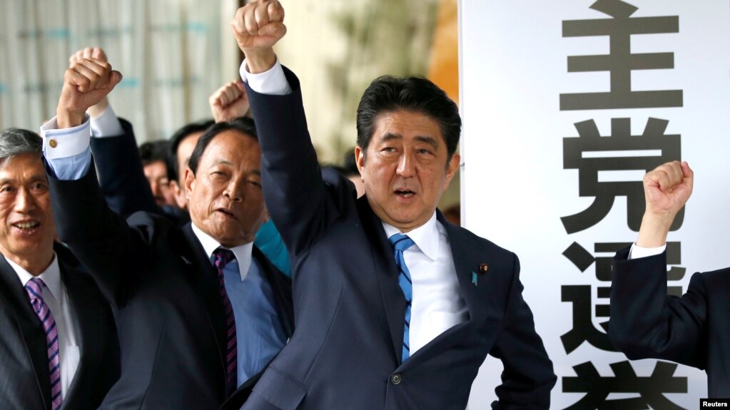 Japan's Prime Minister Shinzo Abe (3rd L) and his party's lawmakers raise their fists as they pledge to win in the upcoming lower house election, at their party headquarters in Tokyo, Japan September 28, 2017. 