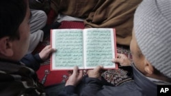 Afghans jointly read Islam's holy book "Quran" during a celebration to mark the anniversary birthday of Islam's Prophet Mohammad at a mosque in Kabul, Afghanistan, February 4, 2012.