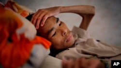  FILE - A patient in the advanced stages of AIDS, lays in his bed at the Mai Hoa Center for HIV and AIDS patients in the village of An Nhon Tay, 60 kilometers, (37 miles) northwest of Ho Chi Minh City, Vietnam, Oct. 10, 2009.