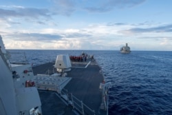 The Arleigh Burke-class guided-missile destroyer USS Dewey prepares for a replenishment-at-sea in the South China Sea on May 19, 2017.