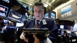 Trader William McInerney works on the floor of the New York Stock Exchange, Jan. 5, 2016. 