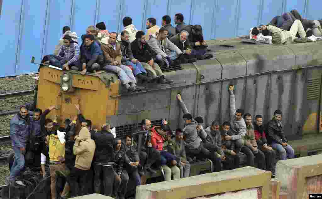 People travel on an overcrowded train in Cairo, Egypt.