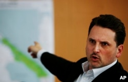 FILE - Pierre Kraehenbuehl, then the operations director of the international Red Cross (ICRC), points to a map during a press conference in Geneva, Switzerland, April 21, 2009.