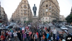 Egyptian protesters chant slogans in Talaat Harb Square in Cairo, Egypt, against the issuance of a new law regulating demonstrations, Thursday, Nov. 28, 2013.