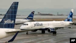 A JetBlue airplane taxis to a gate at Boston's Logan Airport, Jan. 6, 2014.