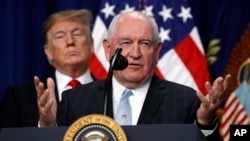 President Donald Trump listens to Agriculture Secretary Sonny Perdue during a signing ceremony for H.R. 2, the "Agriculture Improvement Act of 2018," in the Eisenhower Executive Office Building, Dec. 20, 2018, in Washington. 