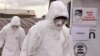 FILE - Health workers are seen wearing Ebola protective gear at an Ebola treatment center at Tubmanburg on the outskirts of Monrovia, Liberia, Nov. 28, 2014.