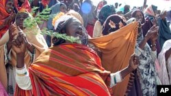 Somalia women celebrate as they welcome the implementation of Islamic Sharia law at Konis stadium, in Mogadishu, Somalia, FILE April 19, 2009.