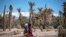 Women walking in Morocco oasis - exode rural au Maroc