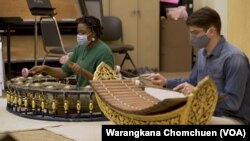 Music students Alexis Hills (L) and Michael Emnett (R) play in Thai ensemble at Kent State University, OH.