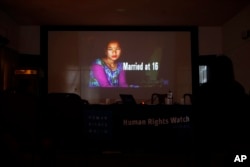 A portrait of a girl who was married at age 16 is shown in a presentation by New York-based Human Rights Watch during the release of a report on child marriage in Nepal in Kathmandu, Nepal, Sept. 8, 2016.