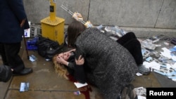 A woman lies injured after a shooting incident on Westminster Bridge in London, March 22, 2017.