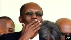 Haiti's former president Jean-Bertrand Aristide blows a kiss after a news conference in Port-au- Prince, March 18, 2011