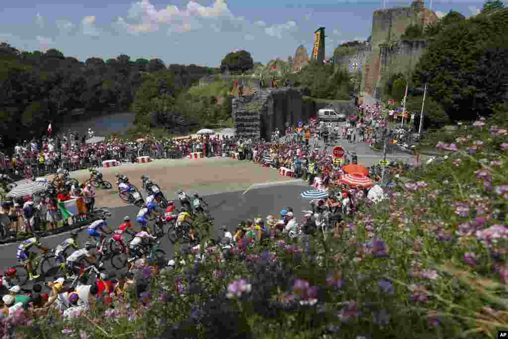 The pack pedals during the second stage of the Tour de France cycling race over 182.5 kilometers (113.4 miles) with start in Mouilleron-Saint-Germain and finish in La Roche Sur-Yon, France.