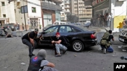 Fighters from Shiite Hezbollah and Amal movements take aim during clashes in the area of Tayouneh, in the southern suburb of the capital Beirut. (File)