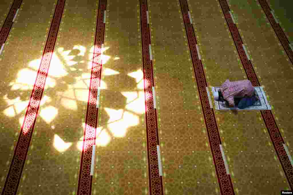 A Muslim man prays at a mosque during the holy fasting month of Ramadan in Shah Alam, Malaysia.