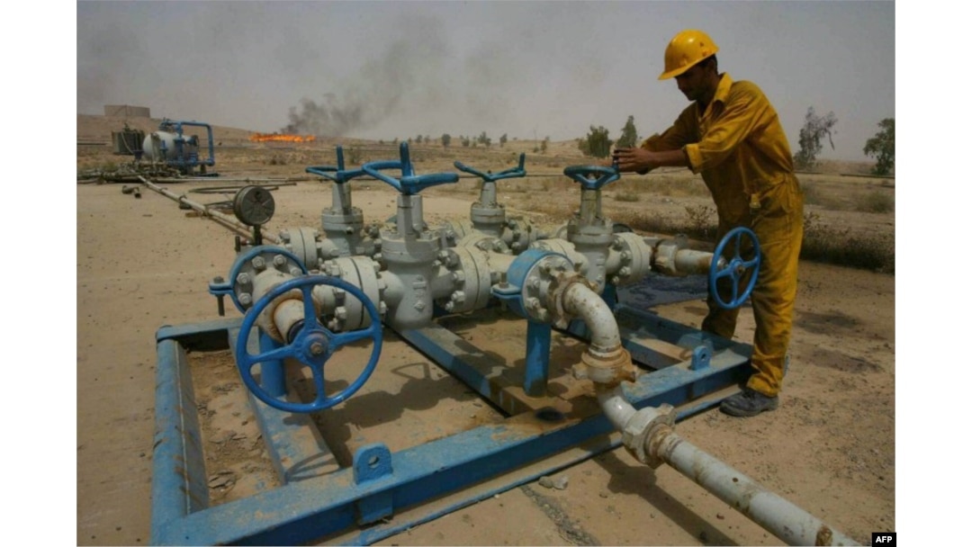 FILE - An Iraqi worker checks the valves at the Kirkuk oil field on June 29, 2009, 225 kms from Baghdad.