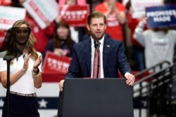 Eric Trump, son of President Donald Trump, speaks during a campaign rally as his wife, Lara watches in Charlotte, N.C., Monday, March 2, 2020. (AP Photo/Mike McCarn)