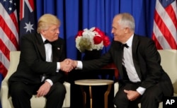 FILE - President Donald Trump and Australian Prime Minister Malcolm Turnbull shake hands during their meeting aboard the USS Intrepid, a decommissioned aircraft carrier docked in the Hudson River in New York, May 4, 2017.