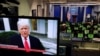 U.S. President Donald Trump is seen making remarks on a television monitor from the White House Briefing Room, after his supporters interrupted the certification by the U.S. Congress of the results of the 2020 U.S. presidential election at the Washington Capitol, in Washington