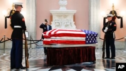 Marines stand guard at the casket of John Glenn as he lies in repose inside Ohio's Statehouse rotunda in Columbus, Dec. 16, 2016. Glenn, 95, the first American to orbit Earth, died last week.